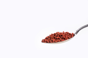 Achiote seeds in the spoon - Bixa orellana.