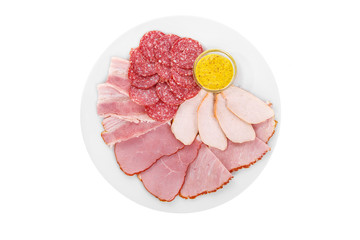 Cold appetizer assorted meat, slices of salami, ham, chicken, carbonate, brisket, boiled pork, fillets, mustard sauce, before alcohol, on plate, white isolated background view from above. For the menu