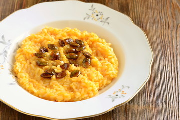 Creamy pumpkin risotto with caramelized pumpkin seeds, copy space