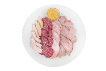 Cold appetizer assorted meat, slices of salami, ham, chicken, carbonate, brisket, boiled pork, fillets, mustard sauce, before alcohol, on plate, white isolated background view from above. For the menu