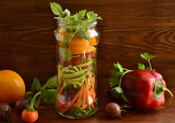 Healthy vegetable salad in a glass jar