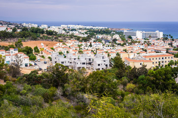 Fototapeta na wymiar Scenic landscape of houses on the background of a calm blue sea horizon