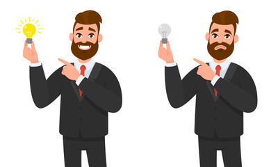 Happy businessman holding bright bulb and pointing to it. Unhappy businessman holding bulb and pointing and standing against isolated white background.  Innovation and idea concept illustration.