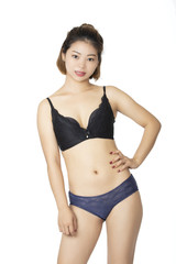 Fototapeta premium Chinese woman posing in panties and bra on white background