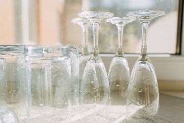 Inverted clean washed glasses on the kitchen towel