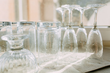 Inverted clean washed glasses on the kitchen towel