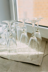 Inverted clean washed glasses on the kitchen towel
