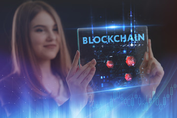 The concept of business, technology, the Internet and the network. A young entrepreneur working on a virtual screen of the future and sees the inscription: blockchain