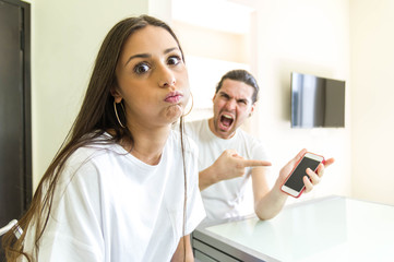 Bored woman fighting with her jealous husband snort looking at the camera