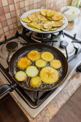 Roast zucchini in the frying pan in the kitchen