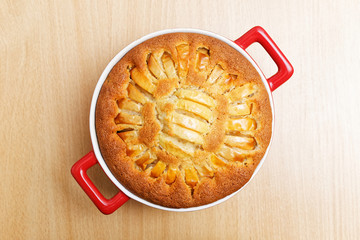Homemade pastry - pie with apples on wooden table. Top view.