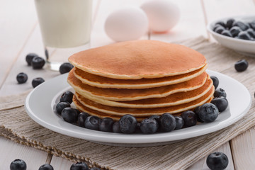 Piled pancakes with blueberries