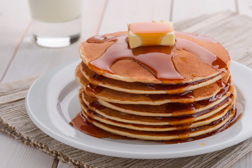 Hot pancakes under maple syrup