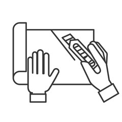 graphic designer hands cutting a paper