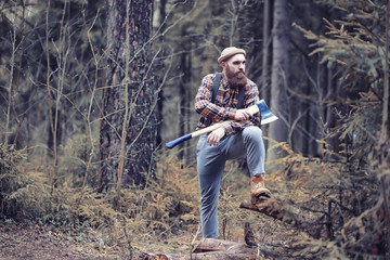 Naklejka premium Autumn rainy weather and a young man with an umbrella