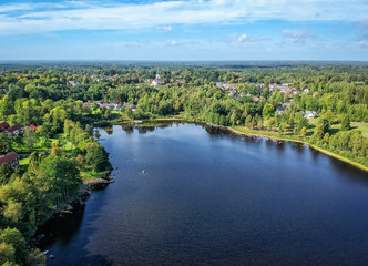 Fototapeta na wymiar Aerial landscape over Swedish lake and village in September