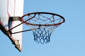 basketball backboard with ring against blue sky