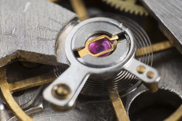 Macro detail of the ruby ​​in the mechanism of a wristwatch / Extreme close up of the inside of a wristwatch case