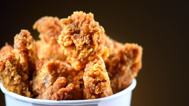 Fried chicken wings and legs. Bucket full of crispy kentucky fried chicken. Rotation 360 degrees. 4K UHD video footage. Ultra high definition 3840X2160