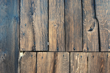 Woodwork. Detail of old brown wooden wall, aged planks nailed with tacks 