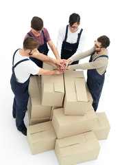 Cheerful movers leaning on stack of boxes isolated on white back