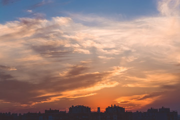  Beautiful sunset over the city. Multicolored sky. Clouds. The sun.