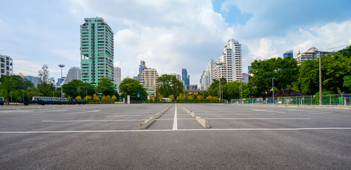 Empty parking lot with city in the background and beautiful blue sky