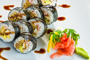 Various kinds of sushi served on black stone