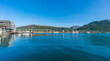 Fototapeta na wymiar View of Tromso Bridge across Tromsoysundet strait in Tromso, Norway
