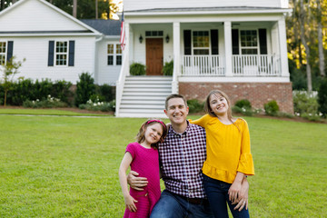Dad and Daughters Standing Outside their New Home Farmhouse