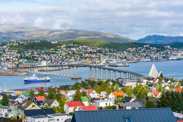 View of Tromso on island of Tromsoya linked across Tromsoysundet strait with Tromsdalen on mainland by Tromso Bridge. Norway