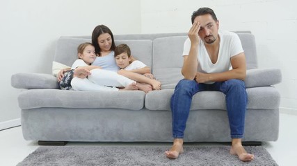 Quarell in a family. Sad husband on the front and his wife and two kids in the back sitting on a sofa. Bottom view