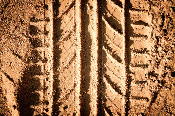 Tyre tracks texture on sand in brown tone