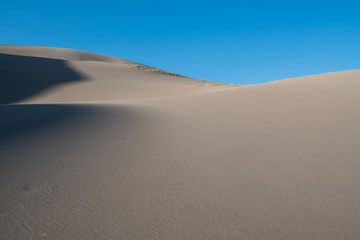 Fototapeta na wymiar Softly curving sand dunes and shadows in Great Sand Dunes National Park, Colorado