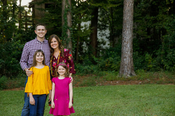 Nuclear Family of Four with Daughters Outside in their Backyard