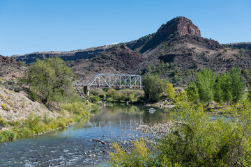 Fototapeta na wymiar Old steel bridge crossing the Rio Grande river near Taos, New Mexico in the Rio Grande del Norte National Monument