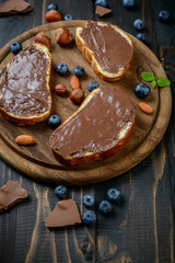 Bread with chocolate spread, chocolate pieces and filbert nuts