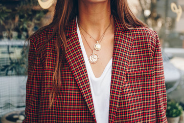 fashion blogger outfit details. fashionable woman check plaid blazer, white t shirt and chunky...