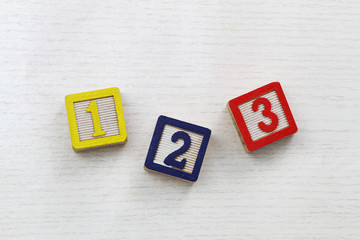 Colorful wooden blocks with numbers 1, 2, 3 written on them
