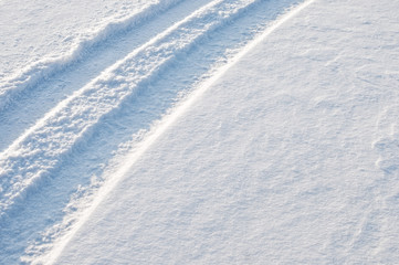 Fototapeta na wymiar Car tire tracks in fresh snow