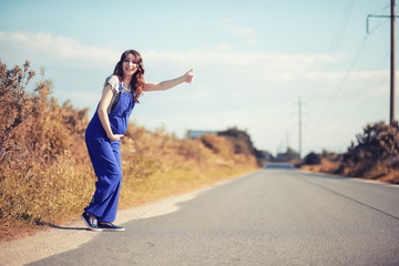 Fototapeta na wymiar Pregnant woman hitchhiking the car