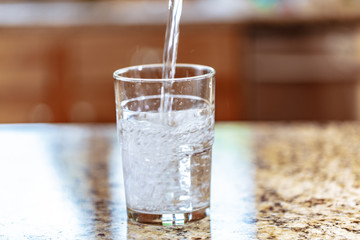 Pouring Water into Glass Up Close Macro