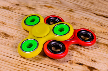 Two fidget spinners on wooden desk