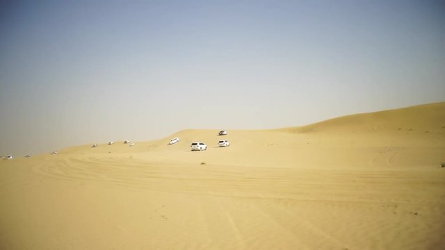 Desert Safari SUVs bashing through the arabian sand dunes. SUV tour through the Arabian desert