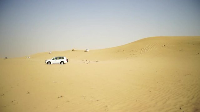 Desert Safari SUVs bashing through the arabian sand dunes. SUV tour through the Arabian desert