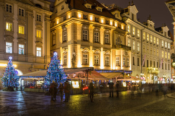 Fototapeta na wymiar Prague Christmas market on the night in Old Town Square with blurred people on the move. Prague, Czech Republic.