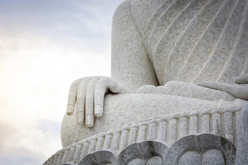 close up of big white mable buddha statue hand with cloudy sky background, copy space, Phuket, Thailand