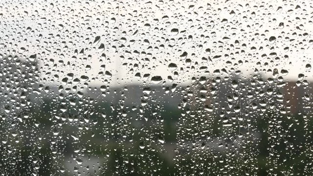 Close Image With Water Drops on the Window in a Rainy Day