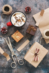 Christmas background with homemade gifts and hot chocolate with marshmallows on a rustic background. The concept of Christmas. View from above, flat lay.