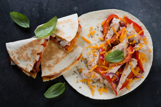 Quesadilla with grilled chicken meat, vegetables and cheddar cheese, horizontal shot, elevated view